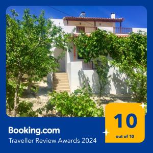 a white house with trees in front of it at Goldy's Villa in Roussospítion