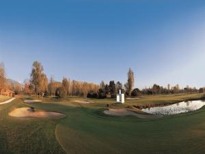 a view of a golf course with a pond at Versilia Golf Resort in Forte dei Marmi