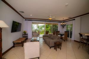 a living room with a couch and a table at Los Suenos Resort Bay Residence 8C in Herradura
