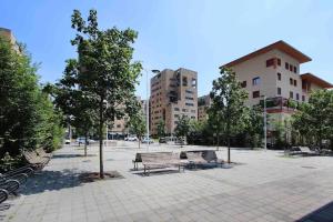 a park with benches and trees and buildings at Bellissimo bilocale con terrazzo in Milan