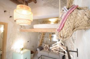 a small room with a bed and a basket on the wall at 209 Livingtarifa Catamaran in Tarifa