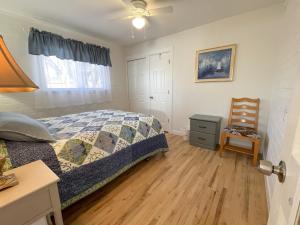 a bedroom with a bed and a chair at Kanab Vacation Destination in Kanab