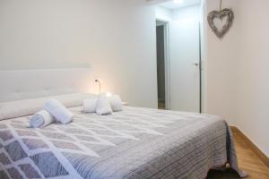 um quarto com uma cama grande com almofadas em Casa Gelina em Gijón