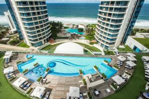 an overhead view of a swimming pool in front of the ocean at Pearls of Umhlanga Apts in Durban