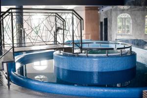 a circular ride in a building with blue water at Jarzębinowy Resort & SPA in Braniewo