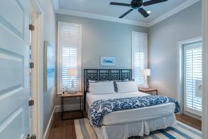 a bedroom with a bed and a ceiling fan at Sunday Morning in Santa Rosa Beach +46 photos
