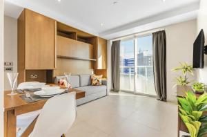 a living room with a dining table and a couch at West One Studio Apartments in Gibraltar