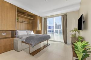 a bedroom with a bed and a large window at West One Studio Apartments in Gibraltar