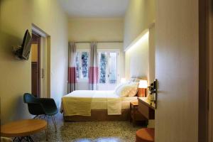 A bed or beds in a room at Athena hotel