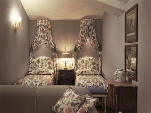 a living room with two beds and a couch at Versilia Golf Resort in Forte dei Marmi +46 photos