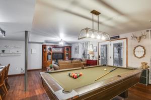 a room with a pool table and a living room at Troy Apartment with Hot Tub, Pool Table and Fire Pit! in Troy