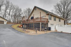 a large house with a balcony and a driveway at Troy Apartment with Hot Tub, Pool Table and Fire Pit! in Troy