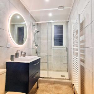uma casa de banho com um lavatório e um chuveiro em Maison Mayel - Logement Entier - Domaine Privé Résidentiel Chic & Nature em Lamorlaye