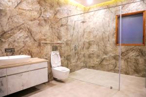 a bathroom with a shower and a toilet and a sink at FILLOW CASA in Gurgaon