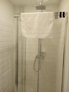 a shower with a white towel on top of it at Tabago Studio 15 in Kędzierzyn-Koźle