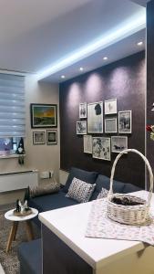 a living room with a couch and a table at Apartment Marija- Kopaonik centar in Kopaonik