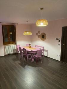 a dining room with a table and purple chairs at Residence La Torre in Acerenza
