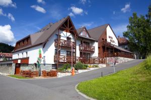 a large building with wooden balconies on a street at Hotel Helena in Rokytnice nad Jizerou