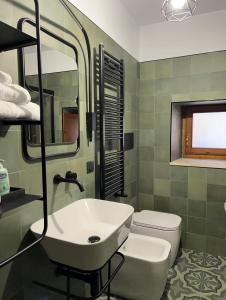 a bathroom with a sink and a toilet at Residence La Torre in Acerenza