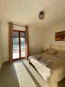 Schlafzimmer mit einem Bett und einem Fenster in der Unterkunft Maison de campagne entre Ajaccio et Porticcio in Cauro