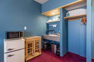 a kitchen with a white refrigerator and a sink at Urban Nest Studios in Halifax