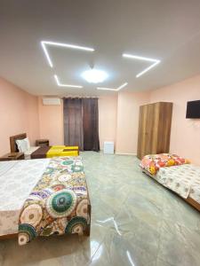a room with two beds and a television in it at HOSTEL BORDJ EL KIFFAN 2 in Fort de lʼEau
