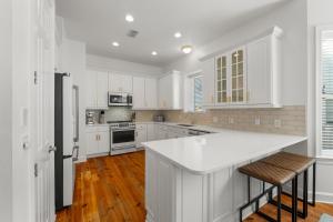 a kitchen with white cabinets and a white counter top at Destin Beach House - Gulf Moon by Panhandle Getaways in Destin