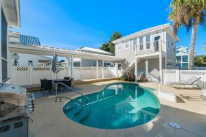 a swimming pool in the backyard of a house at Destin Beach House - Gulf Moon by Panhandle Getaways in Destin