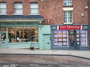 two store fronts on a city street with at Whitchurch High Street Hideaway in Whitchurch