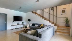 a living room with a couch and a staircase at Villa Amoroso by Villas Holiday in Nova Vas