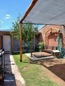 a patio with a swing under a canopy at Alojamiento el Ancla in San Rafael