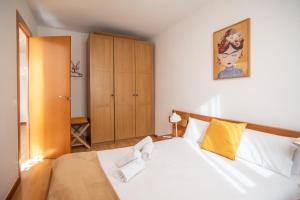sypialnia z białym łóżkiem i żółtą poduszką w obiekcie 41PAR1022 - Luminous apartment in Sant Antoni w Barcelonie