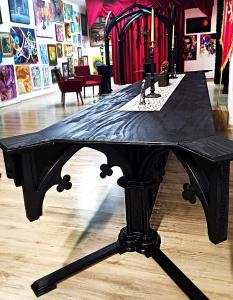 uma mesa preta sentada em cima de um piso de madeira em Galeria Design Art em Florianópolis