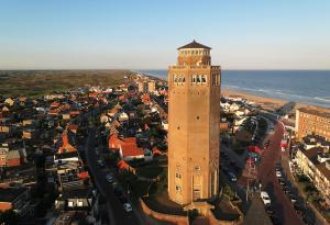 an overhead view of a city with a clock tower at Casa la Vida Beach House in Zandvoort