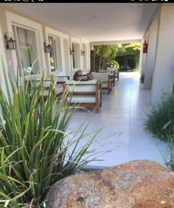 une terrasse avec des chaises longues et un grand rocher. dans l'établissement Finca La Puebla, à La Consulta