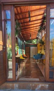 an open hallway with a wooden ceiling and tables and chairs at Moçamba LODGE Contêiner in Florianópolis