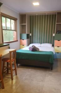 a bedroom with a bed with a teddy bear on it at Moçamba LODGE Contêiner in Florianópolis