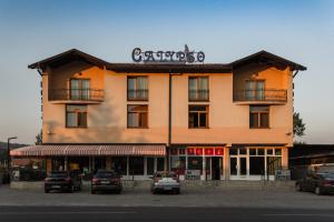 a large building with cars parked in front of it at Motel Calypso Travnik in Travnik
