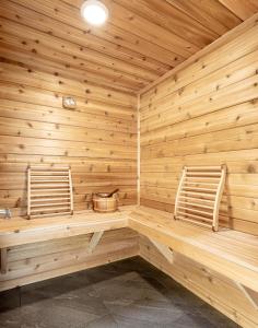 two chairs sitting in a sauna with wooden walls at Copperhead Lodge in Anaconda