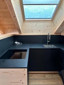 eine Küche mit einem Waschbecken und einem Fenster in der Unterkunft Villa sulla passeggiata in St. Ulrich in Gröden
