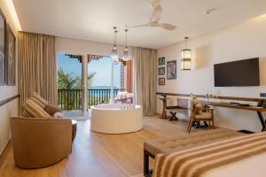 a living room with a couch and a table at The Mora Zanzibar - Luxury All Inclusive in Matemwe