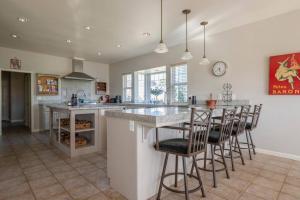 a kitchen with a large island with bar stools at Fraser Family Vineyard Estate Pet-Friendly Home in Plymouth