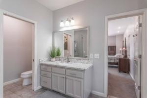 a bathroom with a sink and a toilet and a mirror at Fraser Family Vineyard Estate Pet-Friendly Home in Plymouth +65 photos