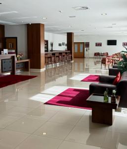 a lobby with couches and tables and a dining room at Placido Hotel Douro - Tabuaco in Tabuaço