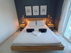 a bedroom with a large bed with two pillows on it at Alexander apartments in Spartià
