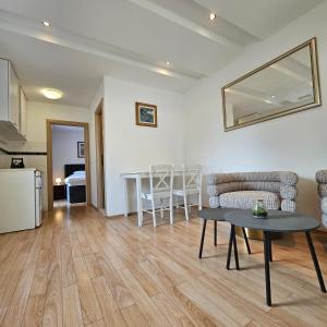 a living room with a table and a kitchen at Apartments Corner in Dubrovnik