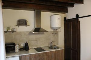una cucina con lavandino e piano cottura forno superiore di Alojamiento Rural La Estrella de David ad Almagro