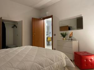 a bedroom with a bed and a dresser and a television at La perla del mare in Trapani
