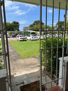 a view of a parking lot with parked cars at Modern 1 Bedroom Apartment - 3 min walk to beach in Saint James
