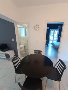 a black table and chairs in a living room at Alexander apartments in Spartia